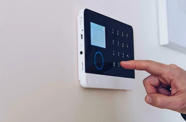 Burglar alarm system keypad being used in a Delray Beach, FL home, ensuring security with quick emergency response.