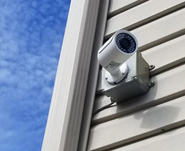Weatherproof security camera installed on a residential home exterior in Fort Lauderdale