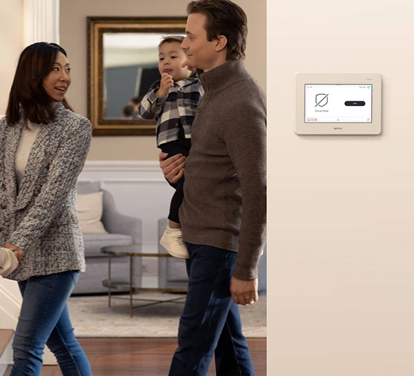 Family adjusting settings on a smart home control panel in their home in Jupiter, FL.