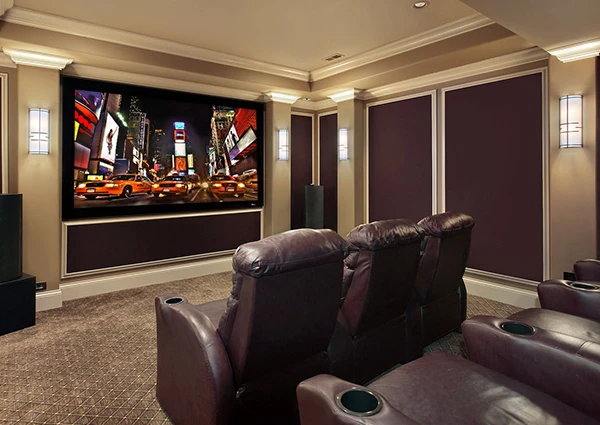 Luxury home theater room with large screen, comfortable leather seating, and ambient lighting.