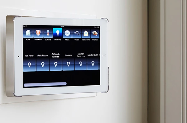 Touchscreen home automation control panel mounted on a wall, showcasing cutting-edge home automation installation services in Palm Beach Island, FL.