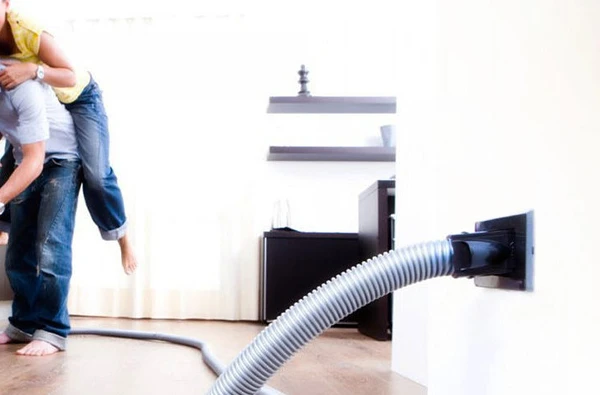 Central vacuum system being installed for enhanced cleaning and convenience in a home.