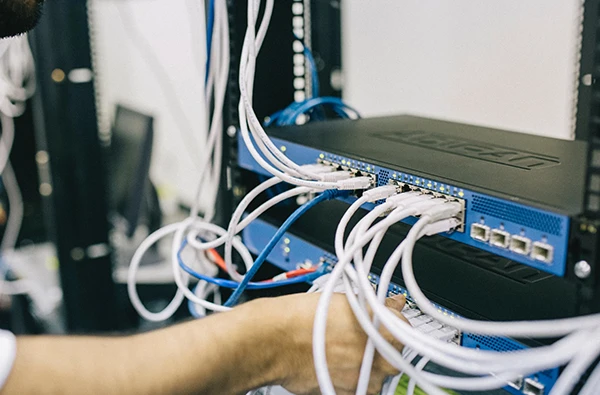 Technician installing network cables for fast internet.