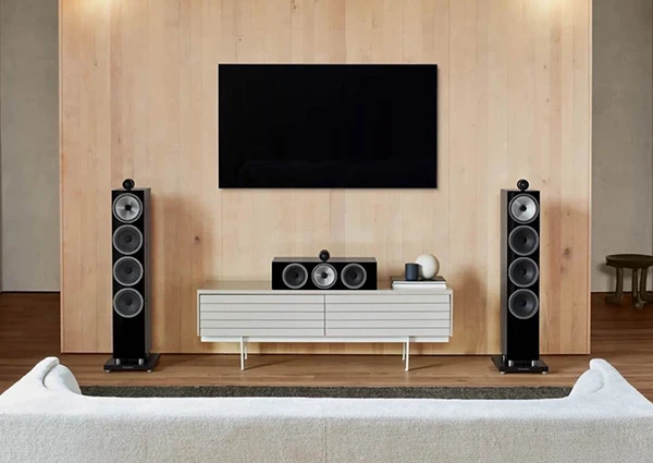 Modern high-quality sound system with tower speakers and flat-screen TV in living room.