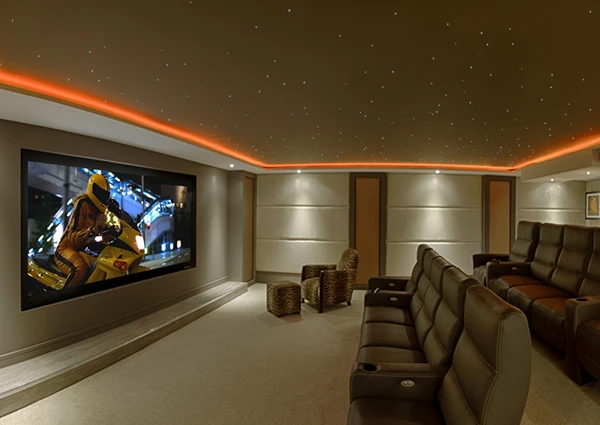 Luxurious home theater room with large screen, surround sound, and comfortable seating showcasing premium home theater installation services in Palm Beach Island, FL.