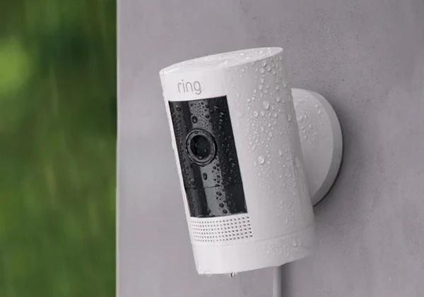 White Ring security camera mounted on an outdoor wall for home surveillance.