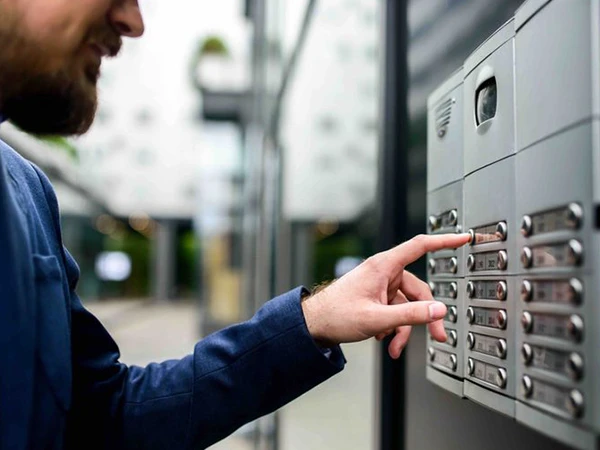 Technician configuring secure intercom system installation in Wellington FL property.