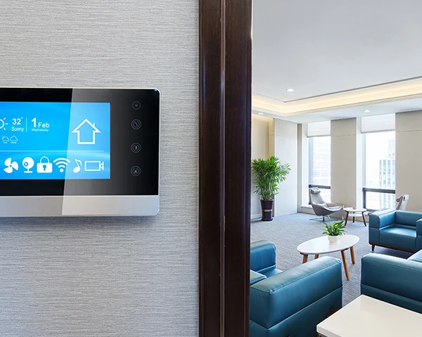 Wall-mounted smart home control panel displaying automation settings in modern living room.
