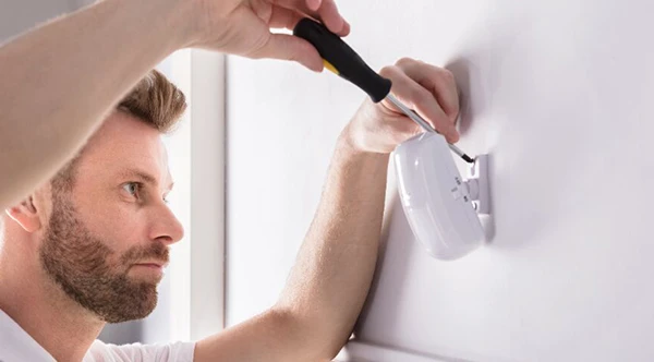 Technician installing smart sensor.