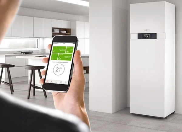 A technician holding a smart security alarm control panel, highlighting trusted electrical experts offering services in Boca Raton, FL.