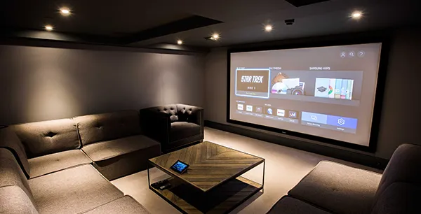 4K home theater projector setup with modern seating arrangement in Stuart FL.