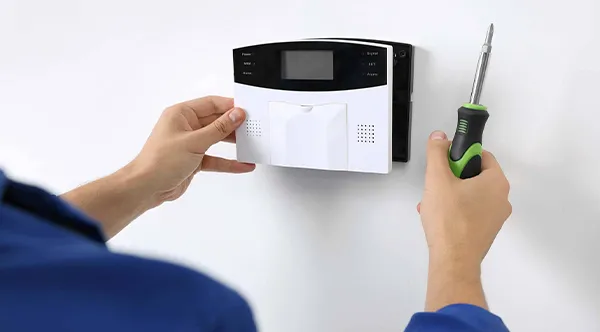 Technician Installing Affordable Intruder Alarm in Fort Lauderdale, FL