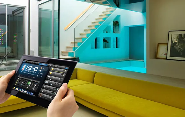 Tablet showing home automation system interface with colorful stairs in background, custom home automation design in Jupiter FL.