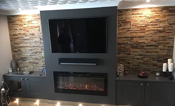 Fireplace TV mounting service showcased with flat-screen TV mounted above a sleek modern fireplace in Wellington, FL.