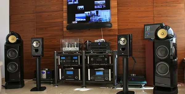 Professional high-end audio setup featuring large speakers, amplifiers, and audio equipment in Wellington, FL home theater.