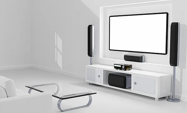 Home theater TV wall mounting setup in bright white living room with surround sound speakers in Palm Beach Gardens, FL.