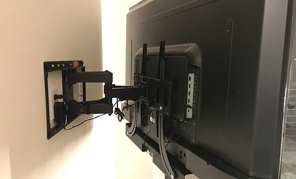 Secure TV wall installation showing back view of a mounted flat screen TV with professional cable management in Boca Raton, FL.